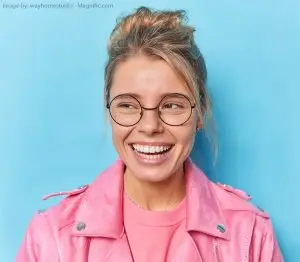 A happy woman showing a beautiful, healthy white smile after a seamless tooth restoration.