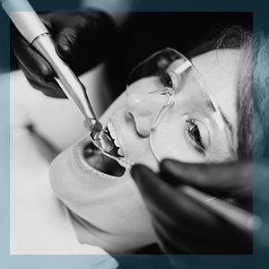 A smiling woman patient visiting a friendly dental hygienist for a professional teeth cleaning and preventative scaling consultation at Shen Dental in Vancouver.